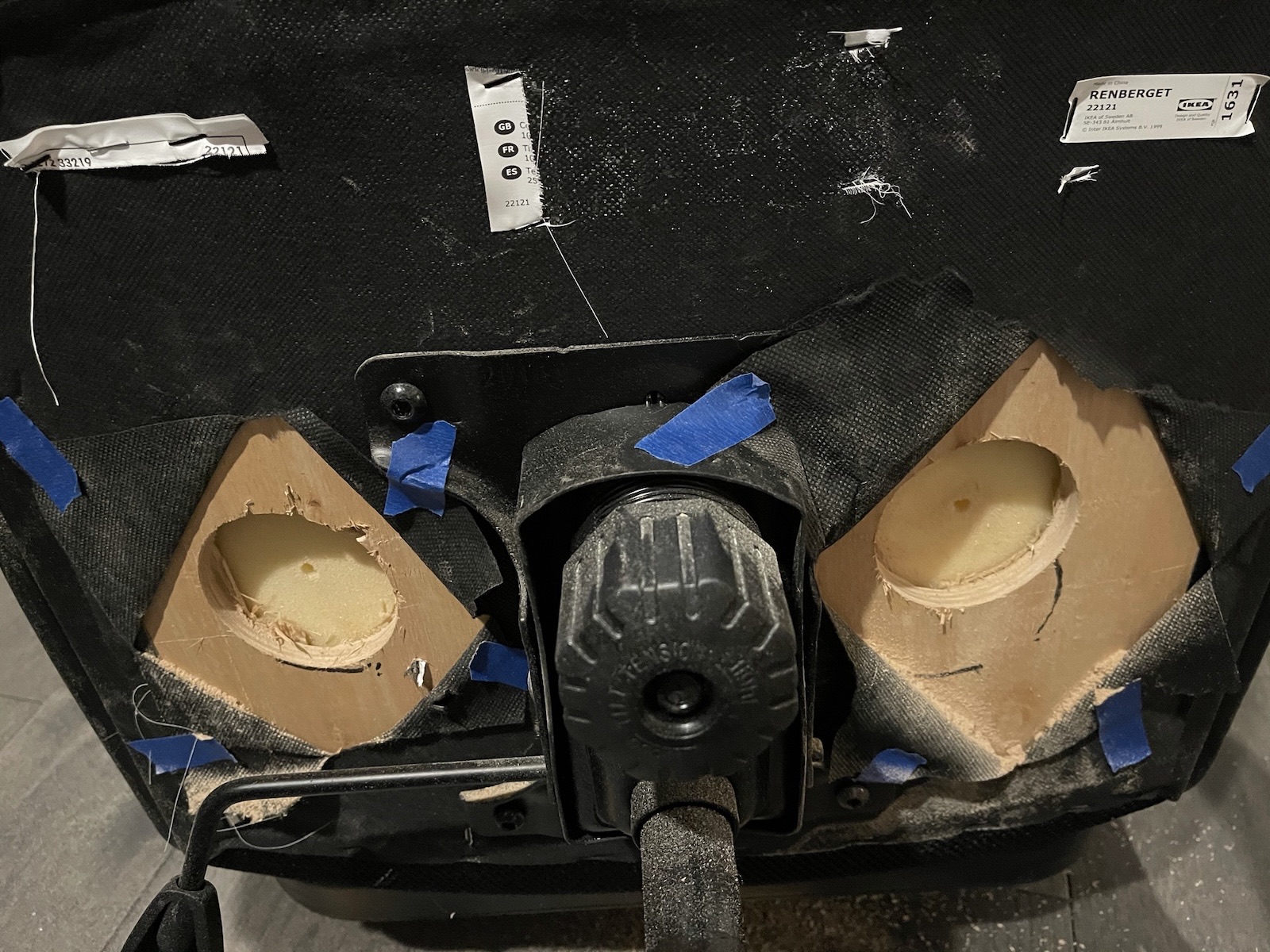 The two holes drilled through the plywood.